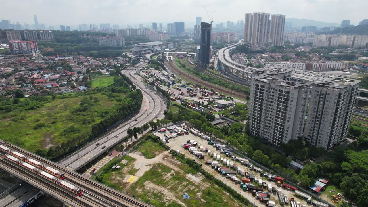 Drone view of Bandar Tasik Selatan (BTS) bus station at Sri Petaling suburb with busy streets on a beautiful day in Kuala Lumpur city, Malaysia, Asia