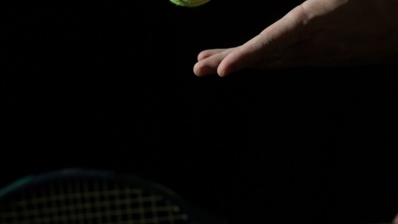 Tennis serve against black background