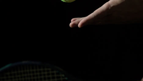 tennis serve against black background