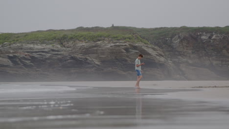 teenager walking on a foggy beach