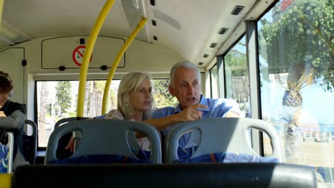 senior couple interacting with each other while travelling in bus 4k