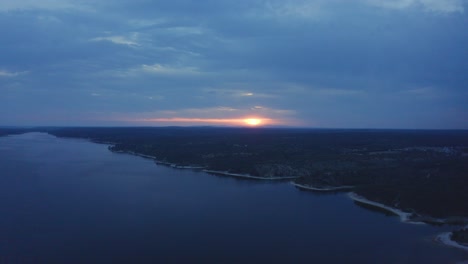 aerial shot of huge sunrise over dam in alentejo, portugal