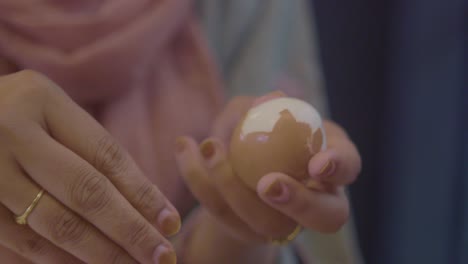 woman peeling a boiled egg