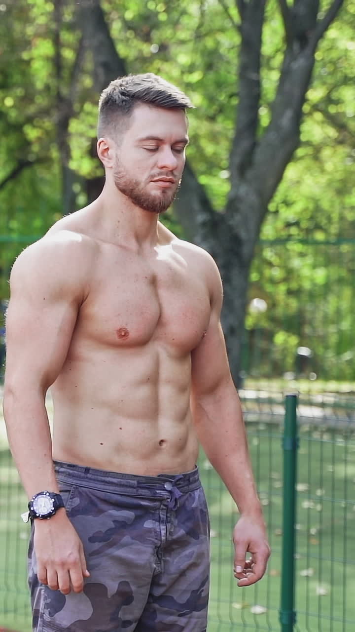 Man posing on racetrack at stadium. Handsome young sports man posing at stadium