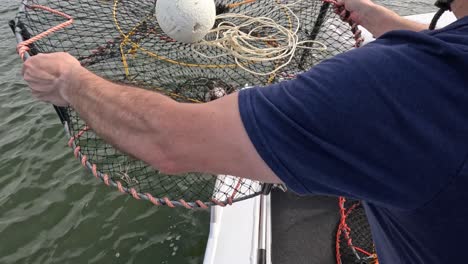 sequence of deploying a crab trap from a boat.