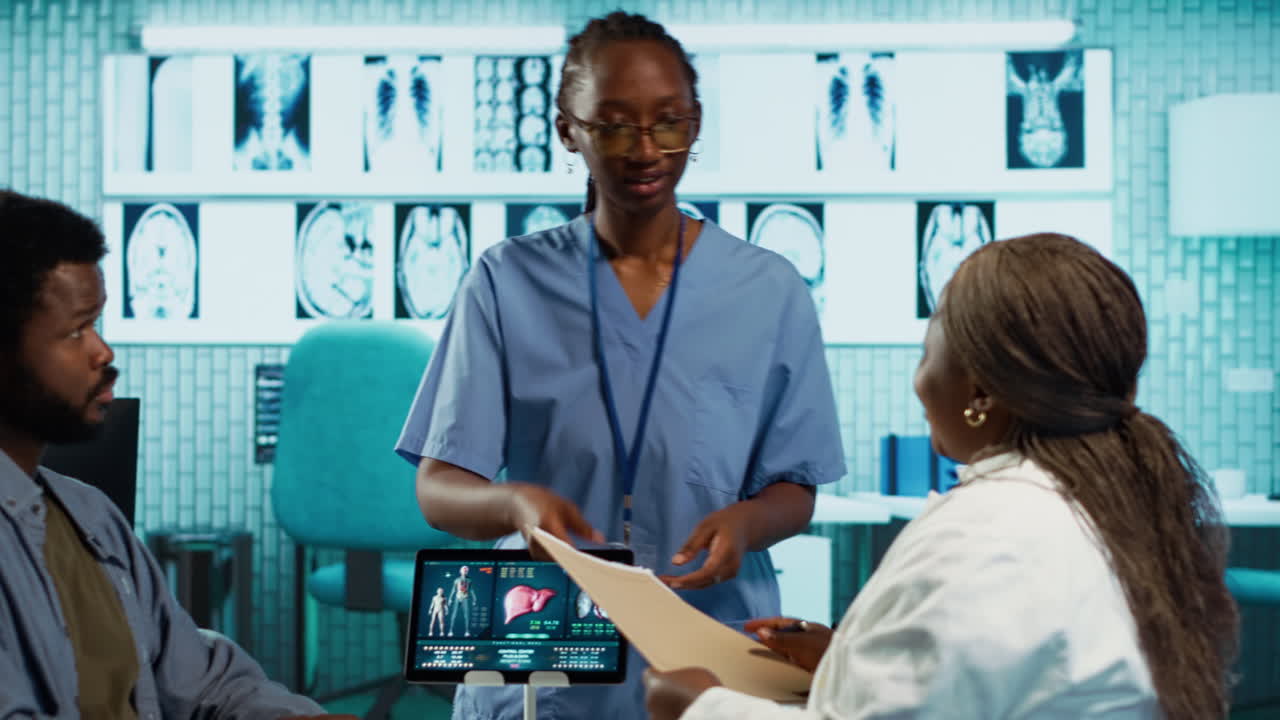 Physician using radiology scans and reports to advise patient during checkup