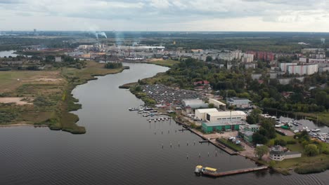 aerial panoramic drone video of a riverside marina on a cloudy day