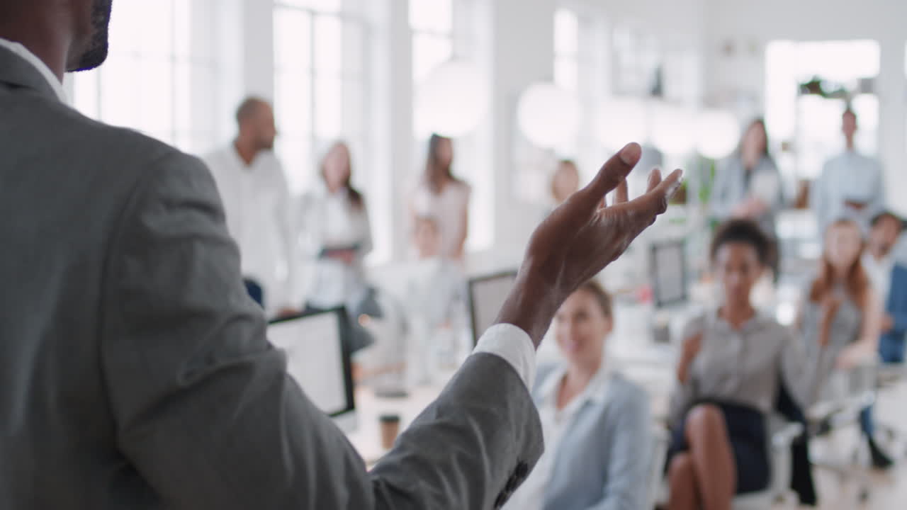 african american businessman team leader presenting in office meeting colleagues sharing leadership ideas in office training presentation seminar