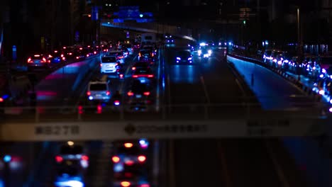 a night timelapse of the miniature traffic jam at the city street in tokyo