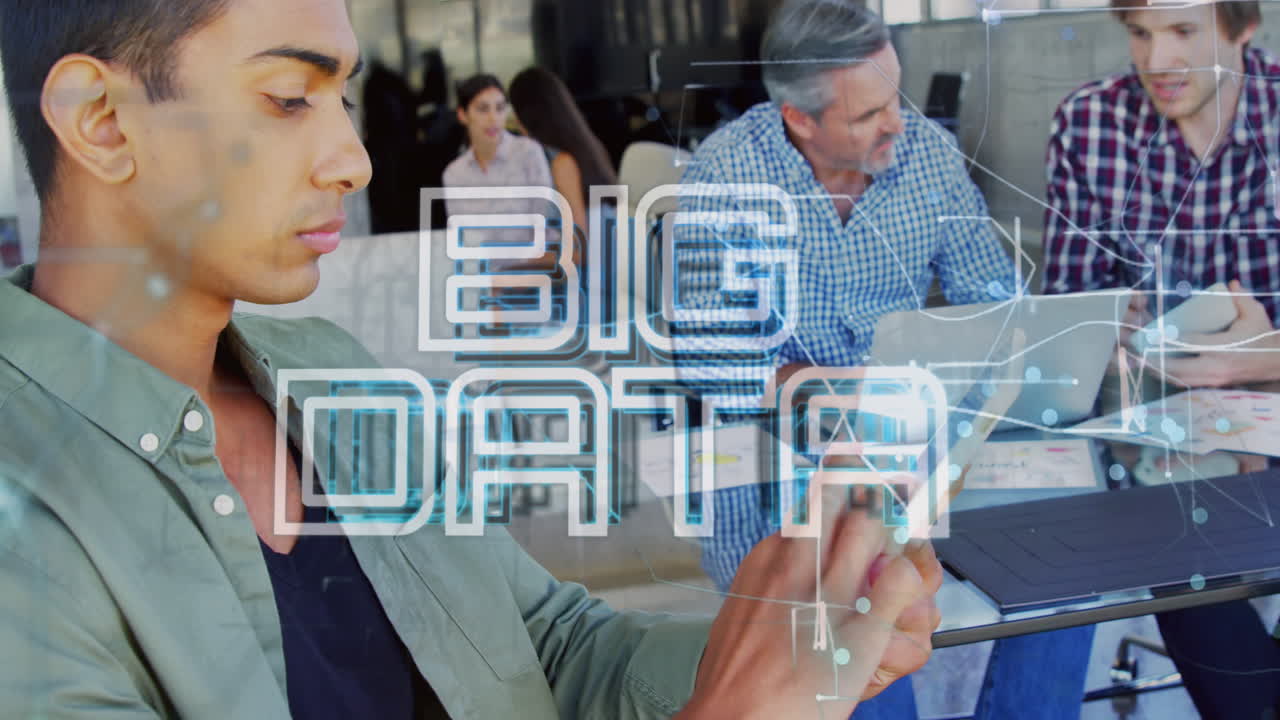 Animation of big data text banner and light trails over biracial man using digital tablet at office