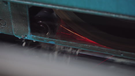 factory saw cutting metal, heavy industrial plant machinery production line