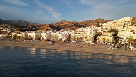 Adult-man-stand-on-SUP-board-paddle-along-La-Herradura-beach-in-Spain