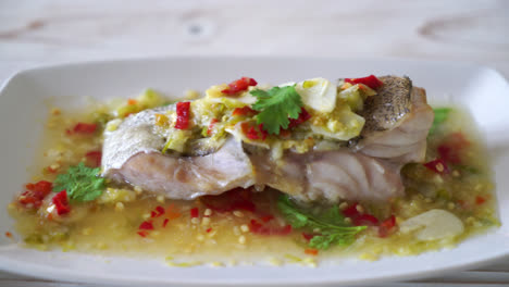 steamed grouper fish fillet with chili lime sauce in lime dressing