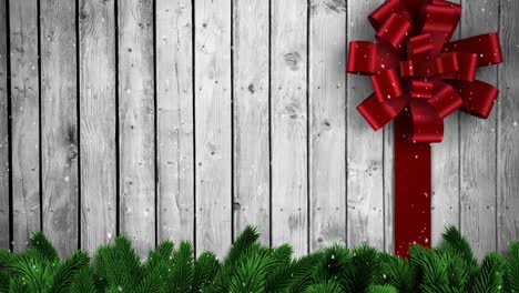 Animation-of-christmas-red-bow-over-wooden-background