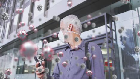 animation of covid 19 cells over senior man wearing face mask