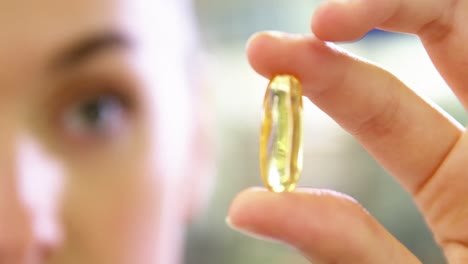 pharmacist checking a capsule