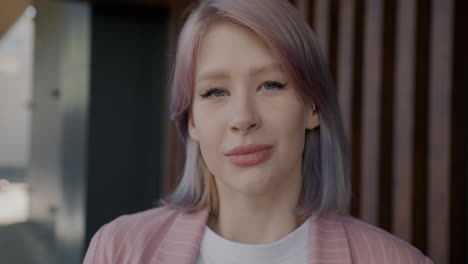 smiling young woman with pink hair