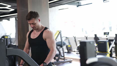 strong athletic fit man in gym. strong muscular male bodybuilder trains in gym