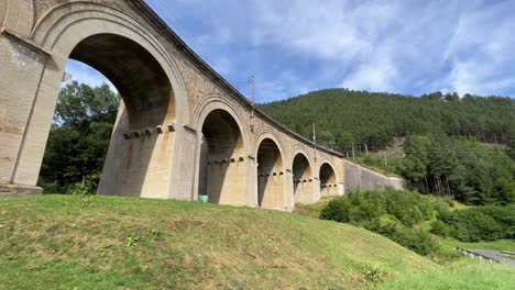 Semmering-Railway-World-Heritage-Unesco-Site-in-Austria-filmed-from-below-in-4K-surrounded-by-forest