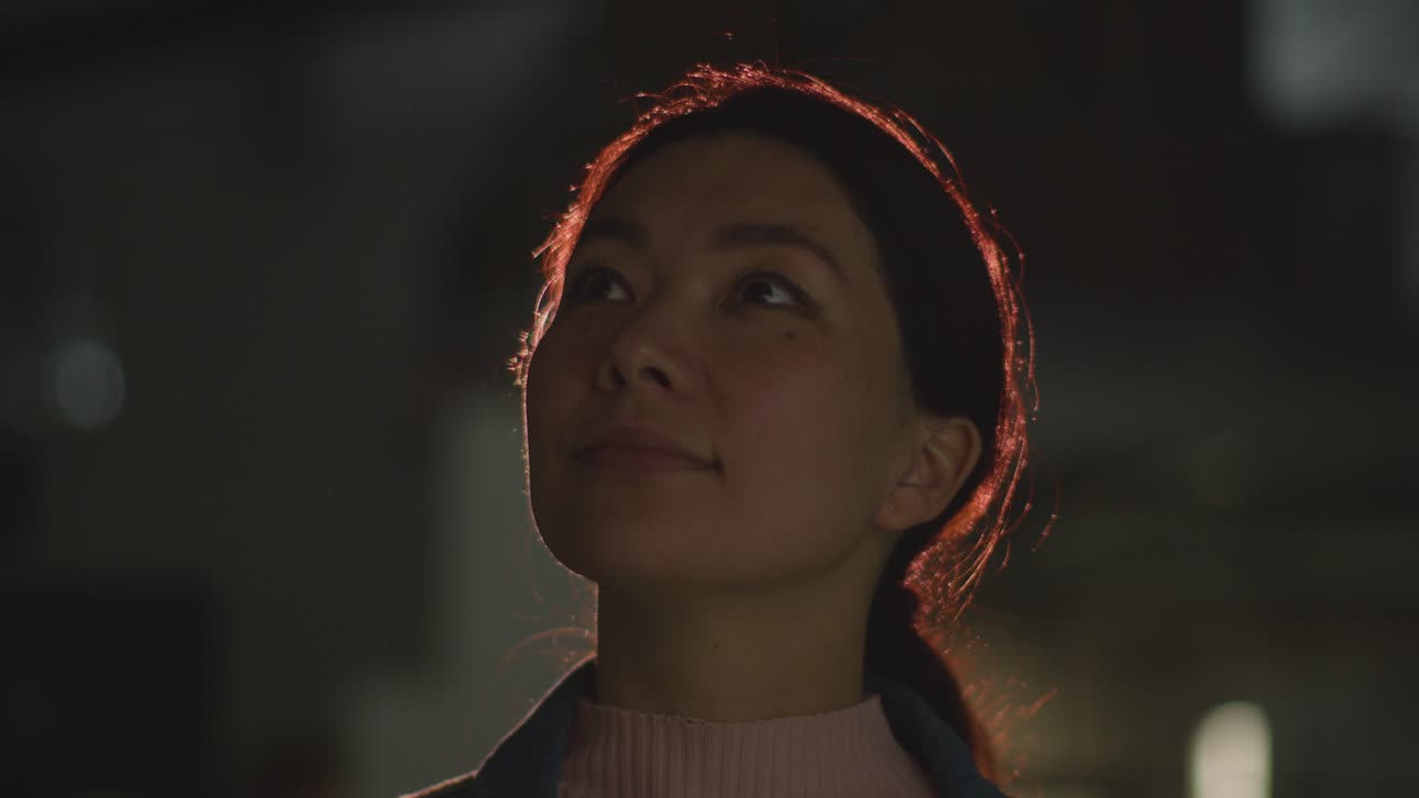 프로젝터 의 빛 으로 백라이트 된 몰입적 인 미술 전시회 를 방문 하는 여자