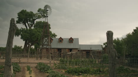 farm in new mexico with rustic wooden windmill turning