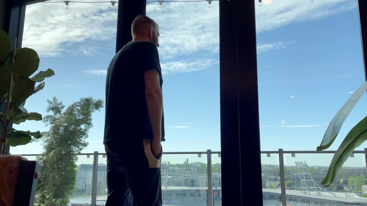 Close Up Shot Of A Confident Caucasian Man Talking On A Cellphone In A Office Space.