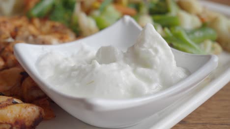 white yogurt sauce in a white bowl