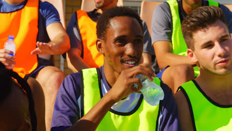 Tired-soccer-players-sitting-in-the-stadium-4k