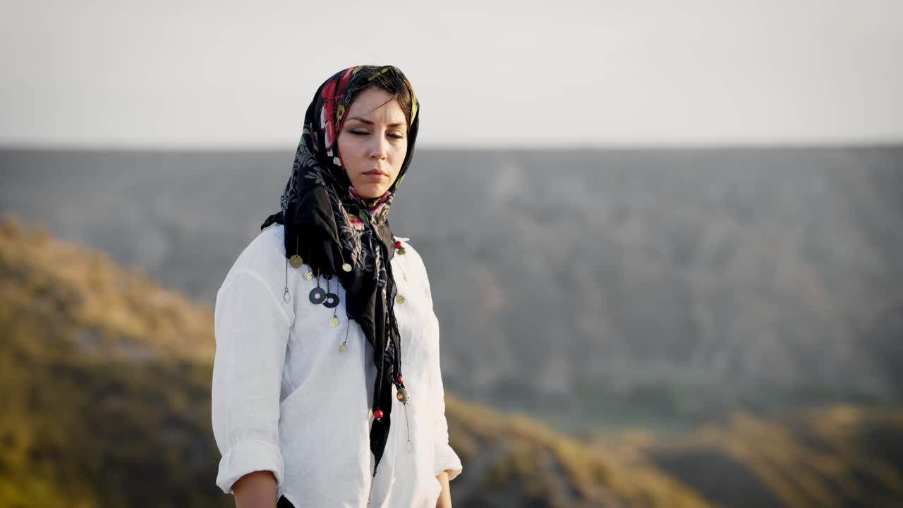 Beautiful woman in headscarf posing in nature
