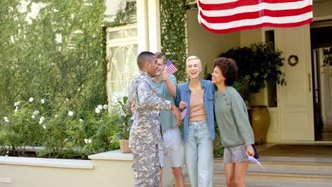 happy diverse male soldier embracing his friends with american flag