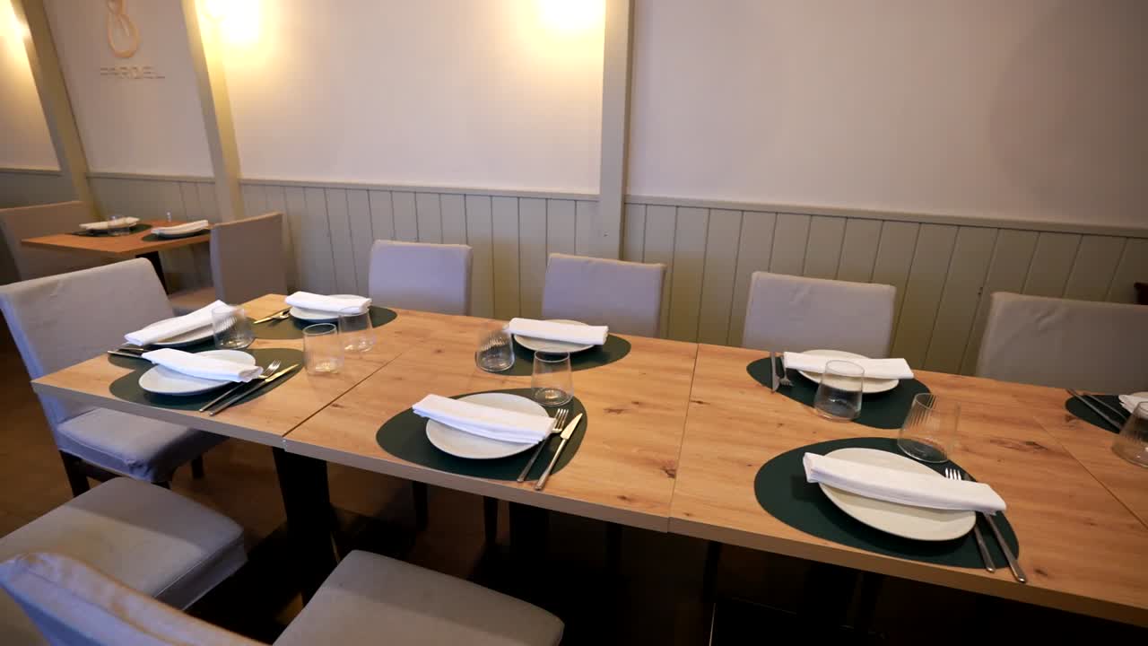 Neatly set dining table with white napkins and glassware in a cozy restaurant