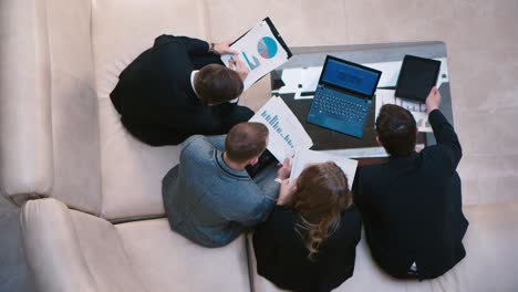 a group of businessmen goes into the lobby of the hotel 2