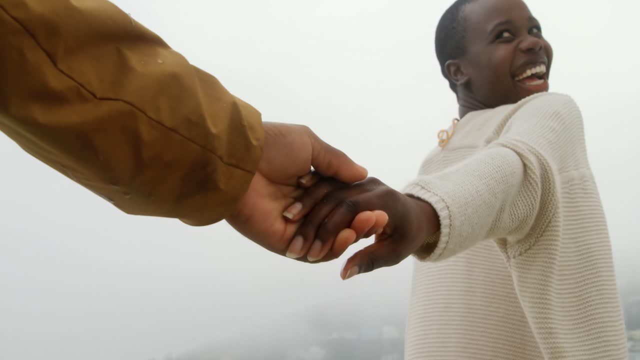 African american couple walking with hand in hand on the beach 4k