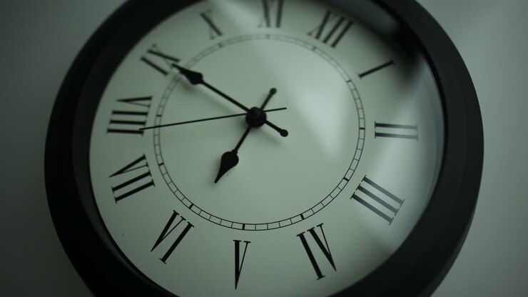 Close-up time lapse of a old-fashioned antiquated wall clock with roman numerals