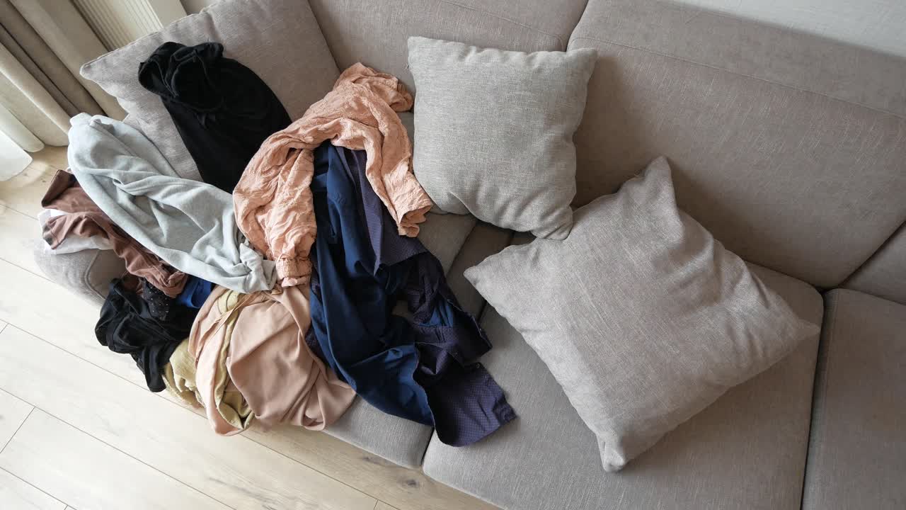 Messy clothes on sofa