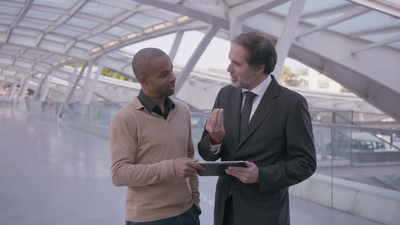 Multicultural businesspeople discussing new projeсt with tablet