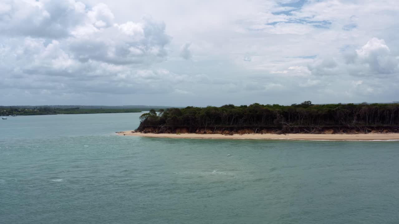 Left trucking aerial drone shot approaching a ferry boat docked on the Uitzicht Panorama in the Guara&iacute;ras lagoon in the tropical beach town of Tibau do Sul near Pipa, Brazil in Rio Grande do Norte