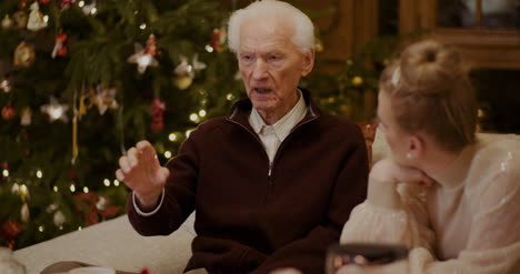 woman talking with grandfather at home during christmas 6