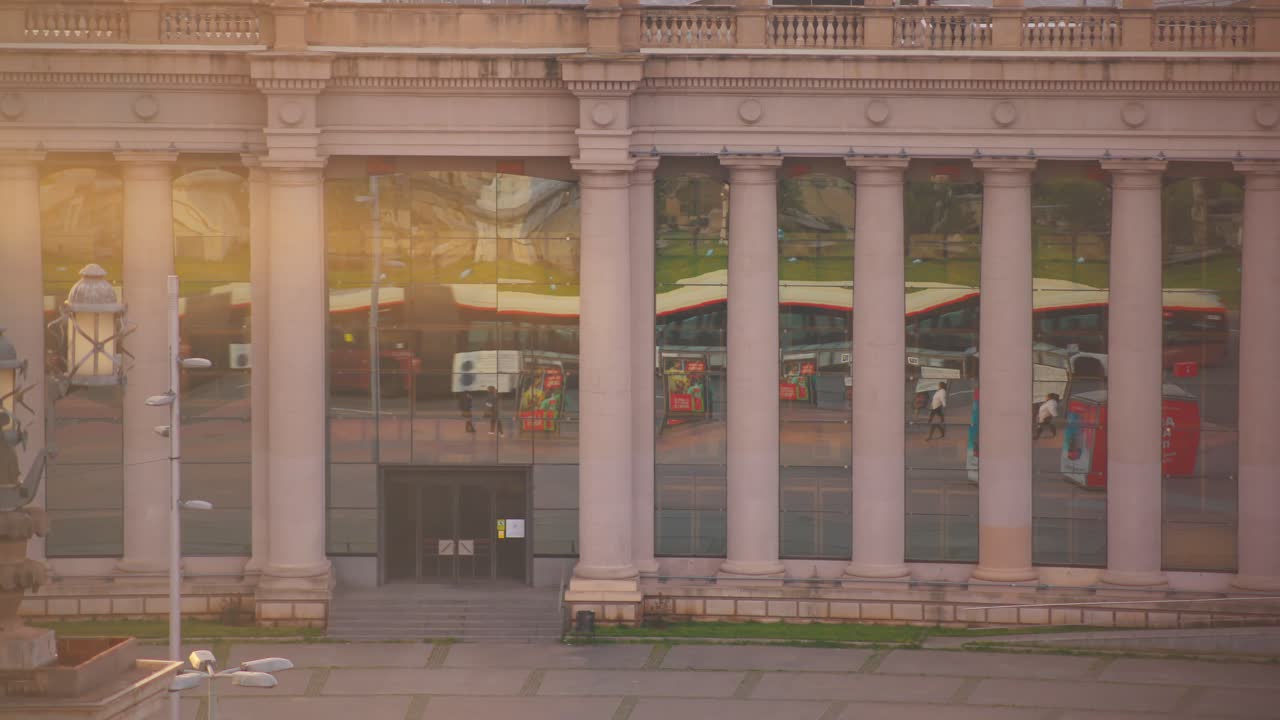 Street traffic reflection on shop windows at Placa d'Espanya Square, Barcelona, Spain