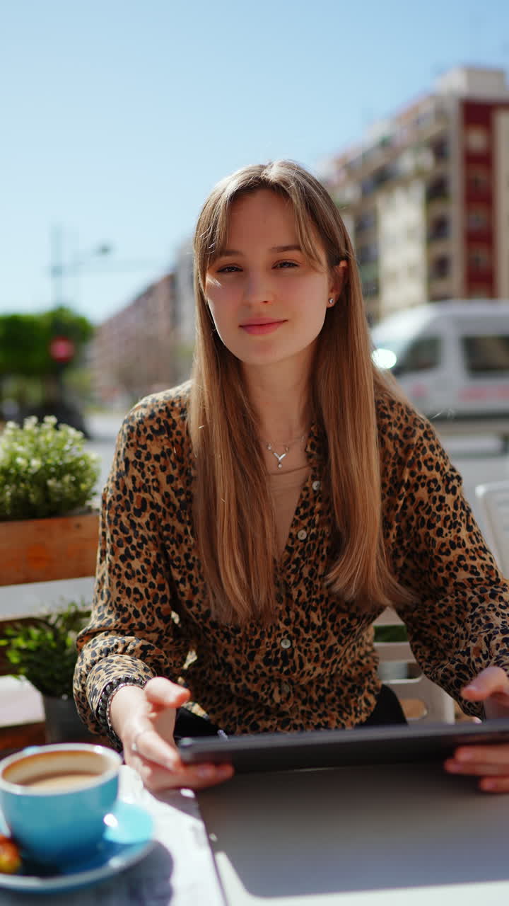 Young woman working outdoors in a cafe