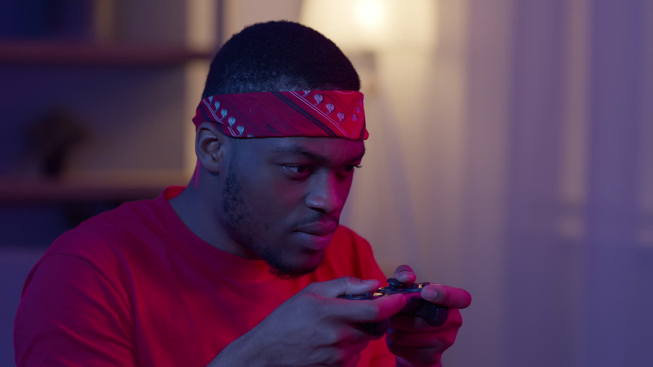 Man Playing Video Games in a Dark Room
