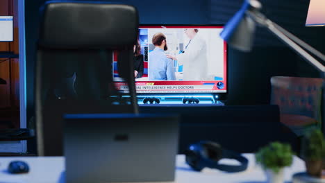 smart tv left open on news broadcast in empty home office with desk