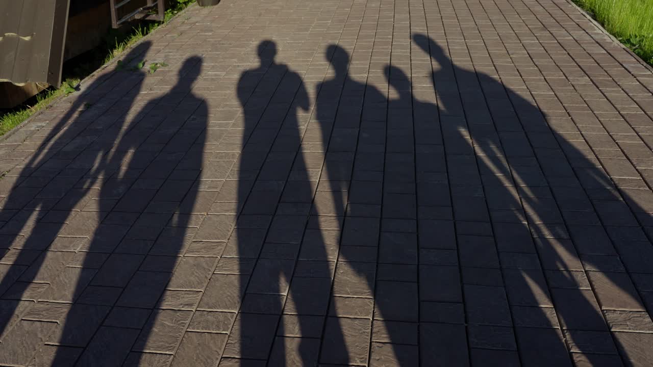 Shadows of People on a Pavement
