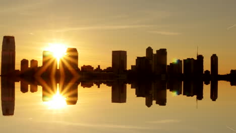 modern city silhouette cityscape skyline apartment building water reflection on lake with background view of sunset, time lapse movie view