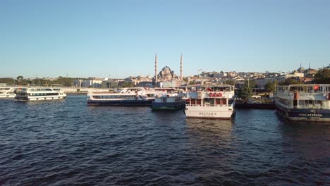 evening, from a ferry on the golden horn in istanbul, a view of the cityscape of eminonu unfolds