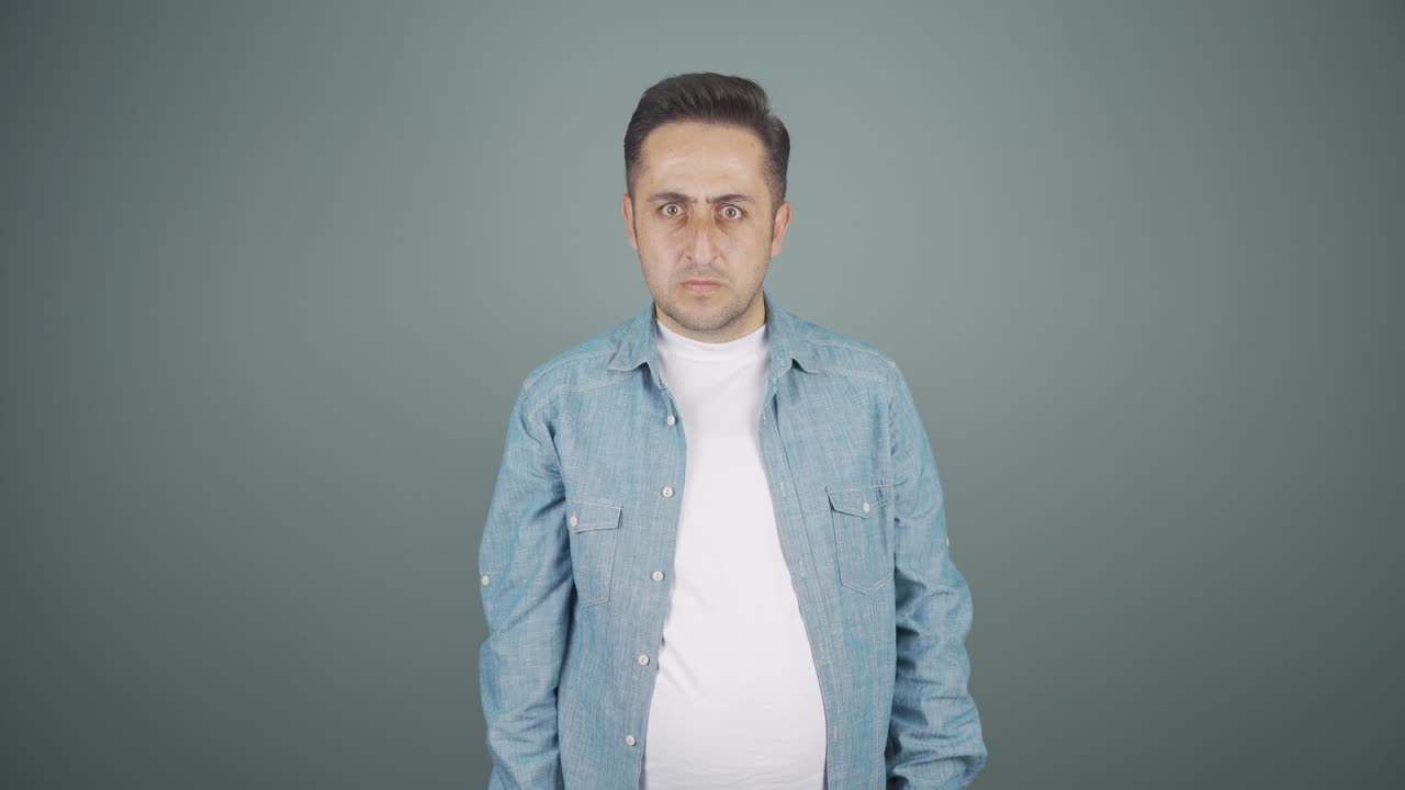 The man is warning by looking at the camera.