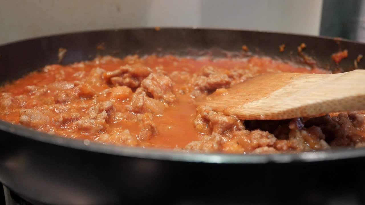Simmering bolognese sauce in a pan stirs up comfort and warmth