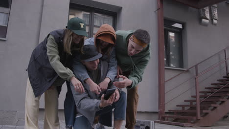 friends using smartphone on the street