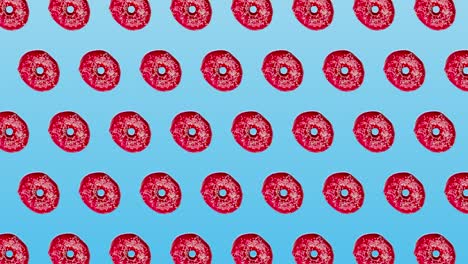 abstract colorful animation - pink donuts moving to the side on blue gradient background - seamless loop. bakery and food concept