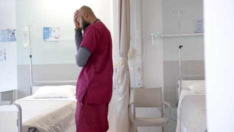 Worried-african-american-doctor-in-hospital-room,-slow-motion